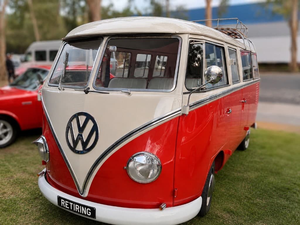 A red and cream vintage Volkswagen Kombi with a RETIRING plate, freedom, adventure and the life retirement makes possible